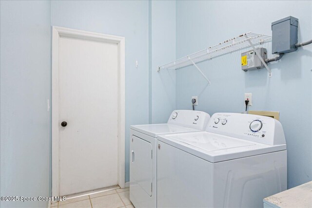 7016 Hammock Trace Dr, Melbourne, FL 32940 - laundry room with washer and clothes dryer and light tile patterned floors