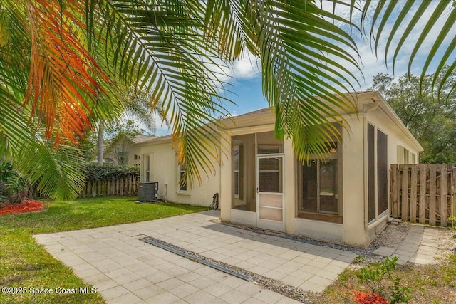 7016 Hammock Trace Dr, Melbourne, FL 32940 - property entrance featuring central AC unit, stucco siding, and a patio
