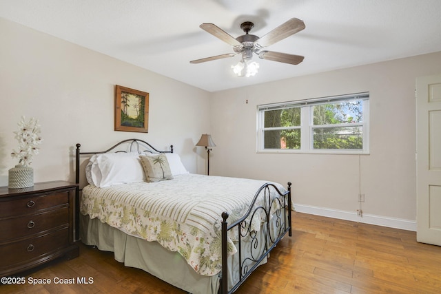 1501 Oranole Rd, Maitland, FL 32751 - bedroom with wood finished floors, baseboards, and a ceiling fan
