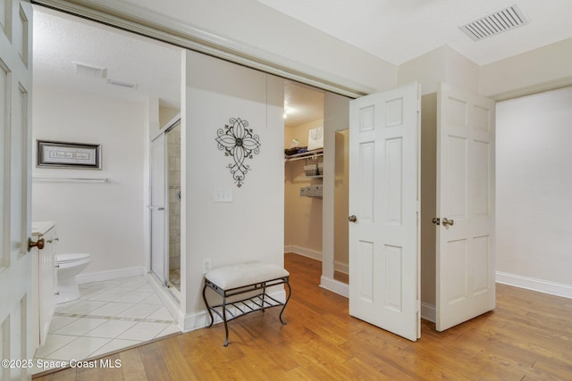 1501 Oranole Rd, Maitland, FL 32751 - full bath with toilet, a stall shower, wood finished floors, and baseboards