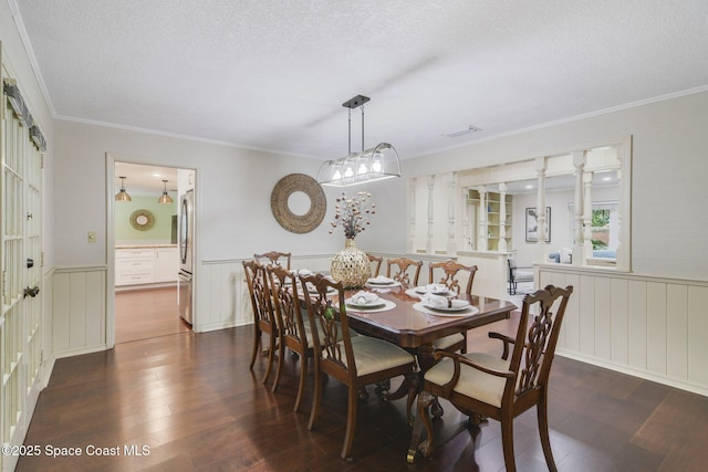 1501 Oranole Rd, Maitland, FL 32751 - dining area with wainscoting, hardwood / wood-style floors, a textured ceiling, crown molding, and a decorative wall