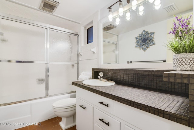 1501 Oranole Rd, Maitland, FL 32751 - bathroom featuring decorative backsplash, toilet, vanity, tile patterned floors, and enclosed tub / shower combo