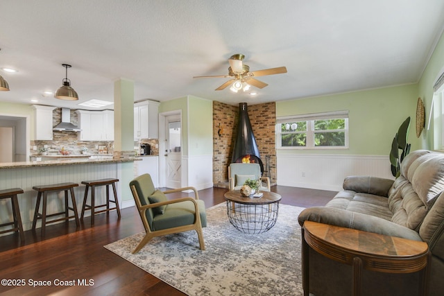 1501 Oranole Rd, Maitland, FL 32751 - living room featuring a wainscoted wall, a ceiling fan, and dark wood-style flooring