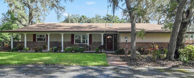 1501 Oranole Rd, Maitland, FL 32751 - single story home featuring brick siding, a front yard, stucco siding, and a porch