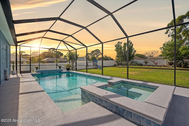 6910 Hundred Acre Dr, Cocoa, FL 32927 - pool at dusk featuring a lawn, a pool with connected hot tub, a lanai, and a patio area