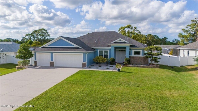 6910 Hundred Acre Dr, Cocoa, FL 32927 - view of front of house featuring a garage, fence, a front yard, and concrete driveway