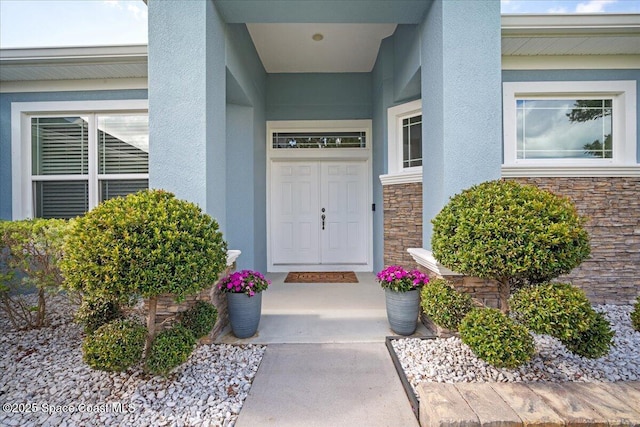6910 Hundred Acre Dr, Cocoa, FL 32927 - doorway to property featuring stone siding and stucco siding