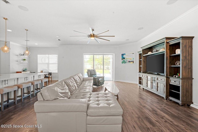6910 Hundred Acre Dr, Cocoa, FL 32927 - living room featuring baseboards, ornamental molding, a ceiling fan, and dark wood-type flooring