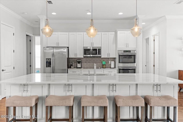 6910 Hundred Acre Dr, Cocoa, FL 32927 - kitchen featuring dark wood-style floors, a spacious island, a sink, backsplash, and stainless steel appliances
