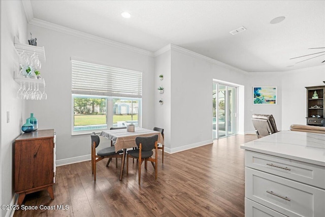 6910 Hundred Acre Dr, Cocoa, FL 32927 - dining room with dark wood-style flooring, visible vents, ornamental molding, and a wealth of natural light