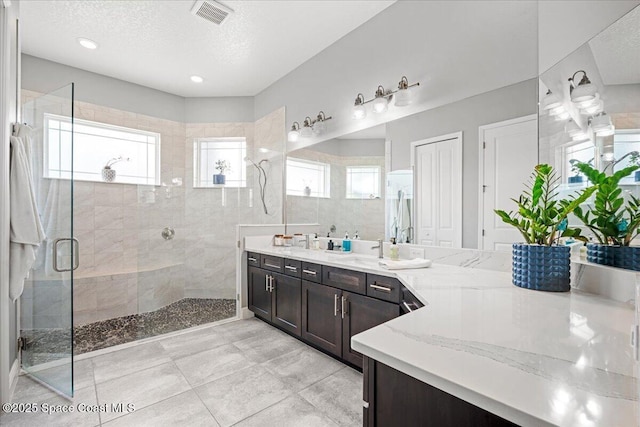6910 Hundred Acre Dr, Cocoa, FL 32927 - full bath with vanity, a stall shower, a textured ceiling, and visible vents