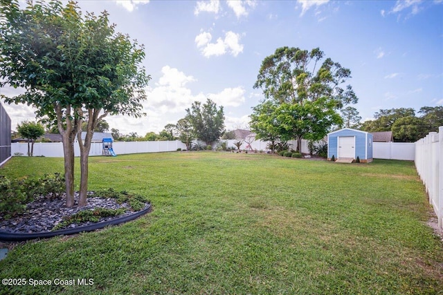 6910 Hundred Acre Dr, Cocoa, FL 32927 - view of yard with a fenced backyard, an outbuilding, and a shed