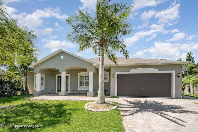 1534 Knoll Ridge Dr, Melbourne, FL 32940 - single story home with an attached garage, driveway, a front yard, and stucco siding