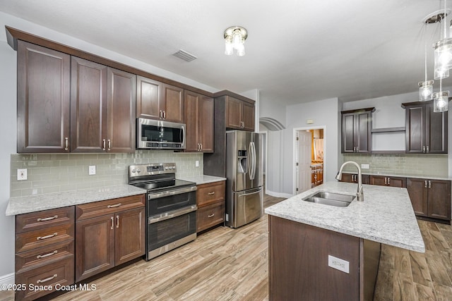 1534 Knoll Ridge Dr, Melbourne, FL 32940 - kitchen featuring light wood finished floors, open shelves, a sink, baseboards, and appliances with stainless steel finishes