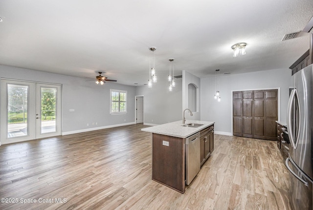 1534 Knoll Ridge Dr, Melbourne, FL 32940 - kitchen with light wood-style floors, ceiling fan, stainless steel appliances, and a sink