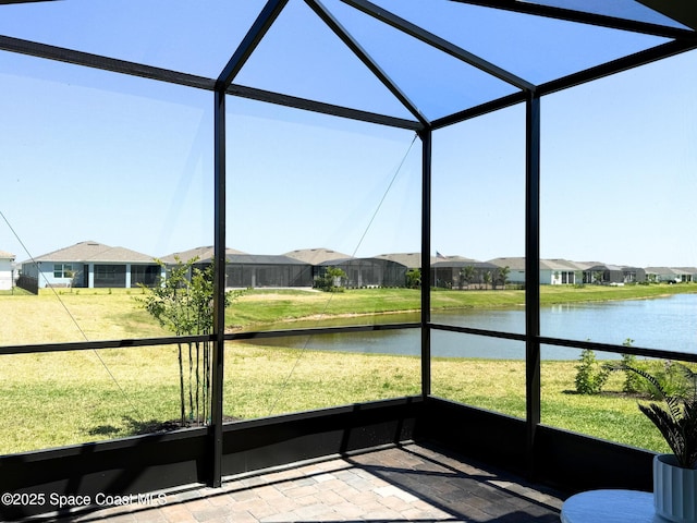 unfurnished sunroom with a water view and a residential view