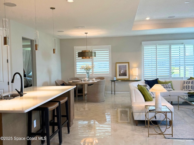 living area featuring marble finish floor, crown molding, visible vents, and recessed lighting