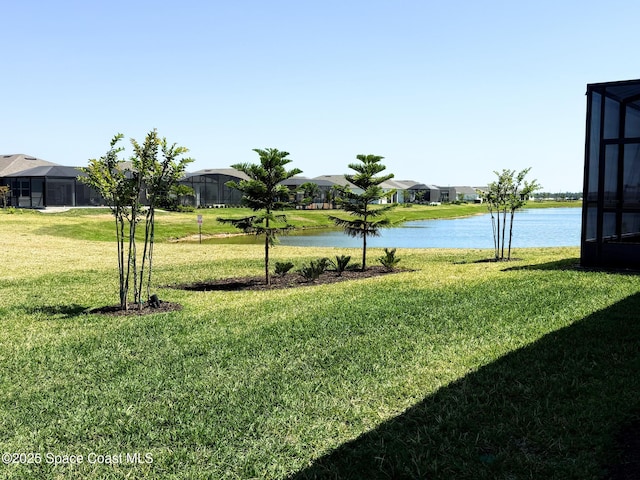 view of yard featuring a residential view and a water view