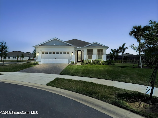ranch-style house with a garage, stucco siding, a front yard, and concrete driveway