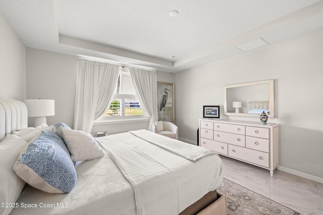 8811 Stormy Sky Ct, Melbourne, FL 32940 - bedroom featuring light marble finish flooring, baseboards, and a tray ceiling