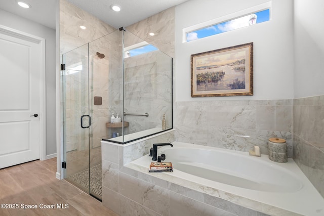 8811 Stormy Sky Ct, Melbourne, FL 32940 - bathroom with a bath, a shower stall, and recessed lighting