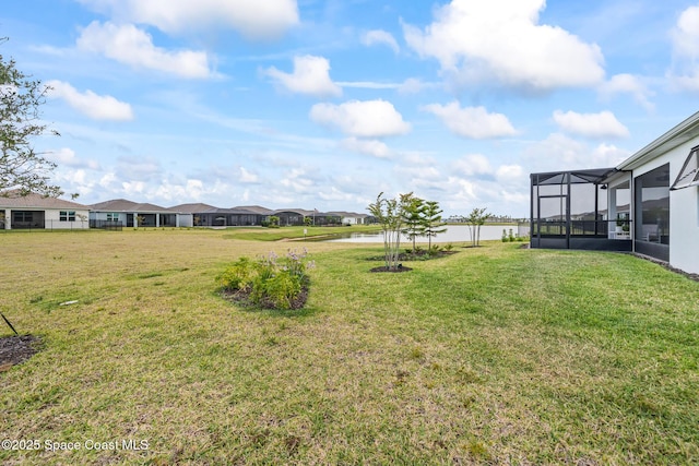 8811 Stormy Sky Ct, Melbourne, FL 32940 - view of grassy yard with a water view, a lanai, and a residential view