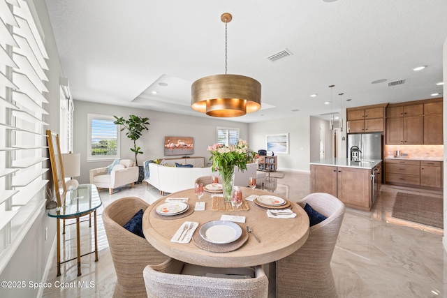 8811 Stormy Sky Ct, Melbourne, FL 32940 - dining room with healthy amount of natural light, light marble finish flooring, recessed lighting, and baseboards