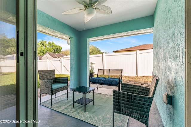 sunroom featuring an outdoor living space, ceiling fan, and a wealth of natural light