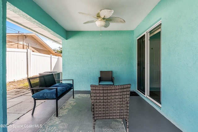 view of patio / terrace with fence, a ceiling fan, and cooling unit