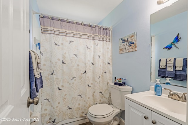 bathroom featuring vanity, curtained shower, and toilet