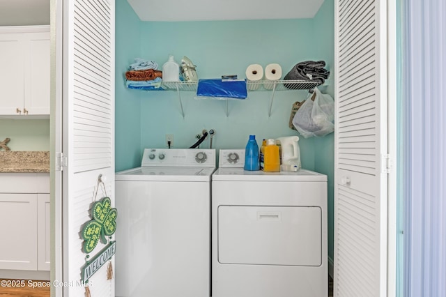 clothes washing area with washing machine and clothes dryer and laundry area