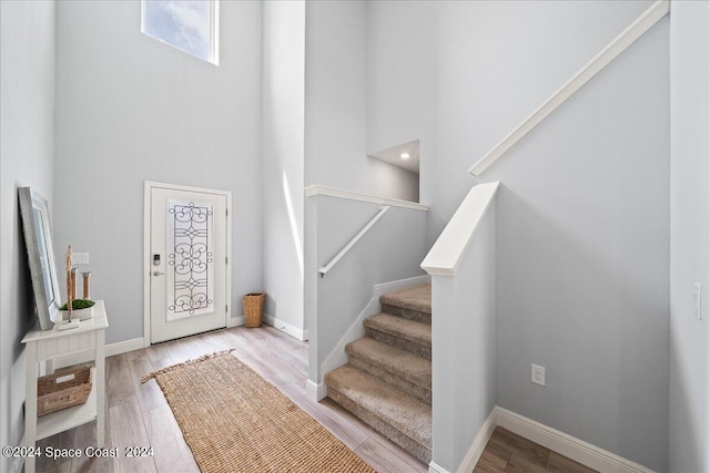 912 Covington Ct, Rockledge, FL 32955 - foyer with wood finished floors, a high ceiling, baseboards, and stairway