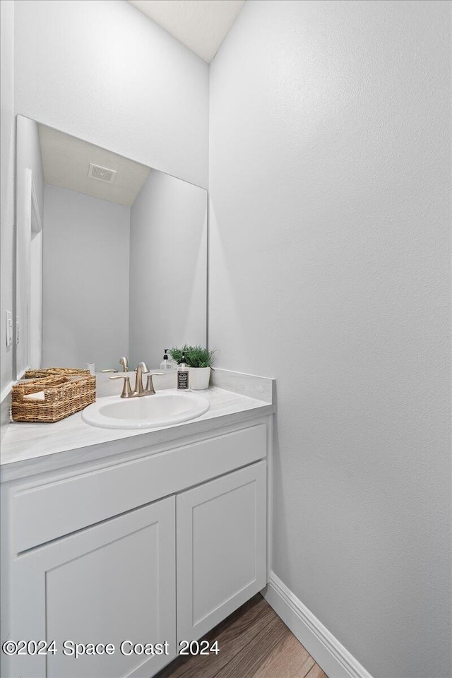 912 Covington Ct, Rockledge, FL 32955 - bathroom featuring baseboards, vanity, wood finished floors, and visible vents