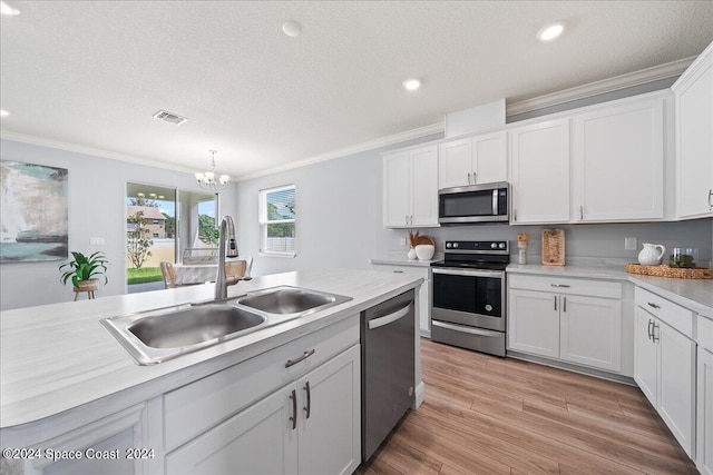 912 Covington Ct, Rockledge, FL 32955 - kitchen featuring stainless steel appliances, a sink, visible vents, a notable chandelier, and ornamental molding