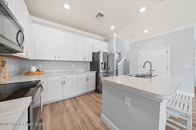 912 Covington Ct, Rockledge, FL 32955 - kitchen with white cabinets, visible vents, ornamental molding, a sink, and stainless steel refrigerator with ice dispenser