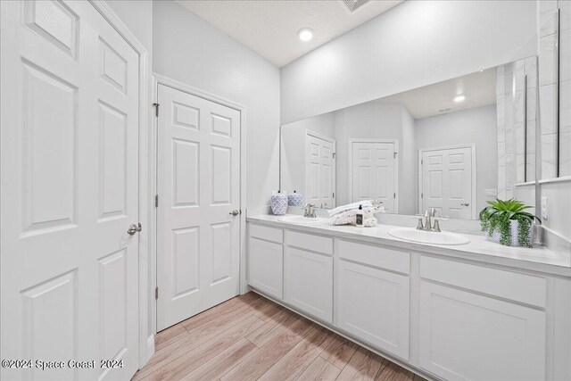 912 Covington Ct, Rockledge, FL 32955 - bathroom with wood finished floors, a sink, and double vanity