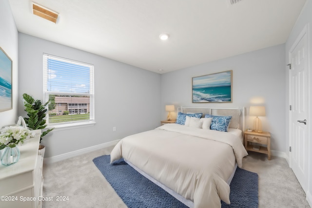 912 Covington Ct, Rockledge, FL 32955 - bedroom with baseboards, visible vents, and light colored carpet