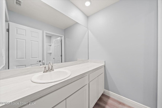 912 Covington Ct, Rockledge, FL 32955 - bathroom featuring wood finished floors, visible vents, vanity, and baseboards