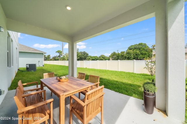 912 Covington Ct, Rockledge, FL 32955 - view of patio with a fenced backyard, outdoor dining area, and central AC unit