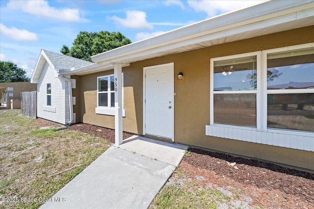 doorway to property with stucco siding