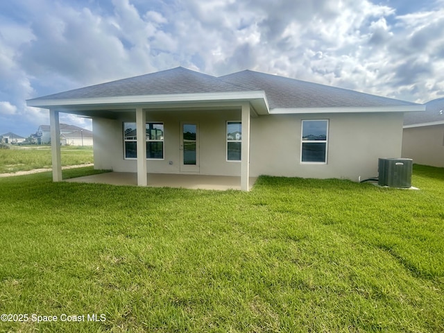 1208 Soleway Ave NW, Palm Bay, FL 32907 - back of property with a patio area, stucco siding, a lawn, and roof with shingles