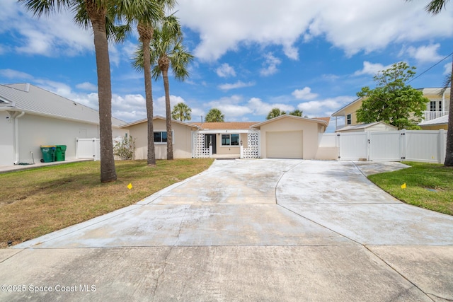 630 Paula Ave, Merritt Island, FL 32953 - single story home with a gate, driveway, an attached garage, and stucco siding