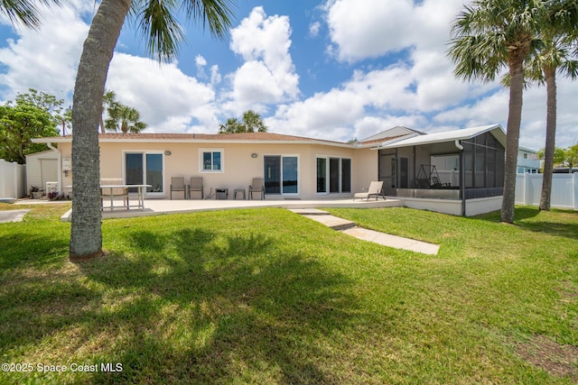 630 Paula Ave, Merritt Island, FL 32953 - rear view of house featuring a sunroom, stucco siding, and a patio