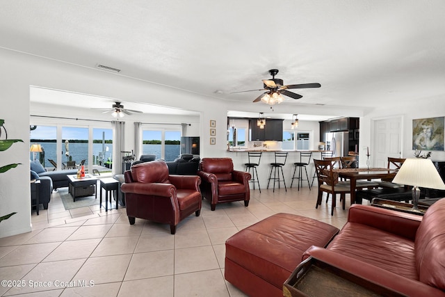 630 Paula Ave, Merritt Island, FL 32953 - living area featuring ceiling fan, light tile patterned flooring, and a water view