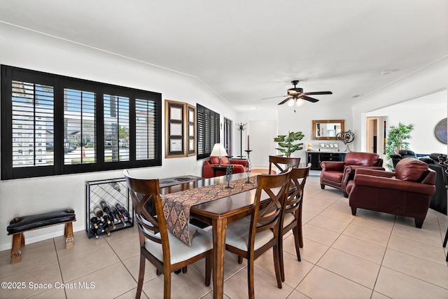 630 Paula Ave, Merritt Island, FL 32953 - dining area with light tile patterned floors, ceiling fan, baseboards, and vaulted ceiling