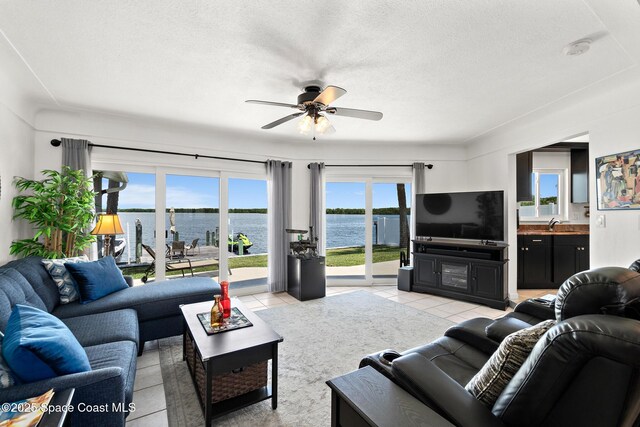 630 Paula Ave, Merritt Island, FL 32953 - living room featuring a ceiling fan, light tile patterned floors, and a textured ceiling
