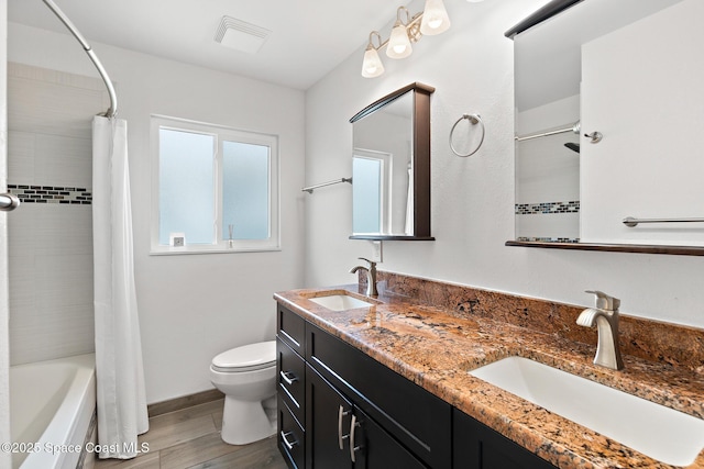 630 Paula Ave, Merritt Island, FL 32953 - bathroom with toilet, wood finished floors, double vanity, and shower / bathtub combination with curtain
