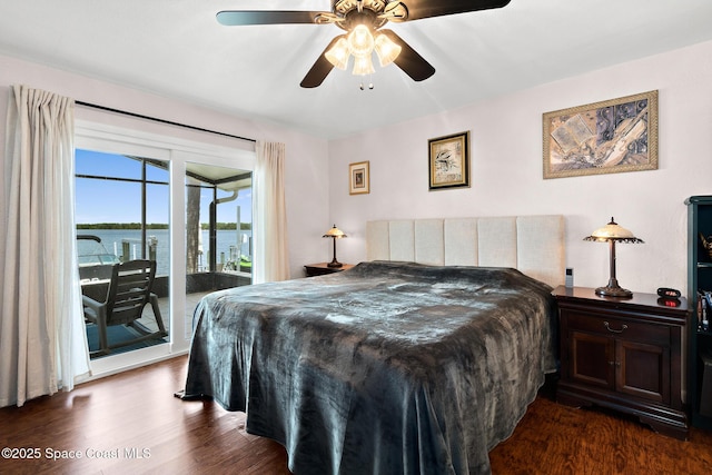 630 Paula Ave, Merritt Island, FL 32953 - bedroom with access to exterior, dark wood-style flooring, a water view, and a ceiling fan