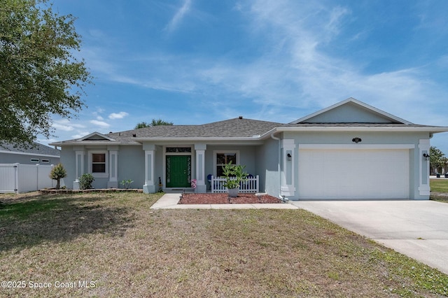 ranch-style house featuring fence, a front yard, stucco siding, an attached garage, and driveway