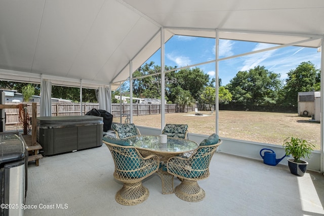 sunroom / solarium featuring outdoor dining area and a hot tub